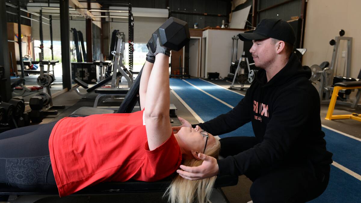 Lisa Vowles working out with her personal trainer to reach the running goal she publicly set as part of the This Time Next Year television show. Picture: Kate Healy