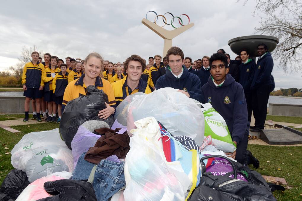 Ballarat Grammar students Laura Munn and Jack Salau inspect donated clothing with St Patrick's College students Harrison Hobbs and Osmond Green-King. Picture: Kate Healy