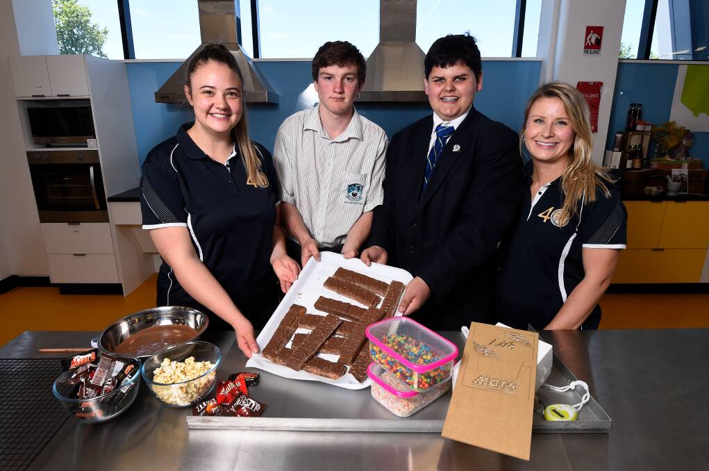 PRODUCT: Mars packaging engineer Imogen Kerr, students Talyn Dart and Jack Miller, and Mars value stream manager Heather Lord talk chocolate. Picture: Adam Trafford