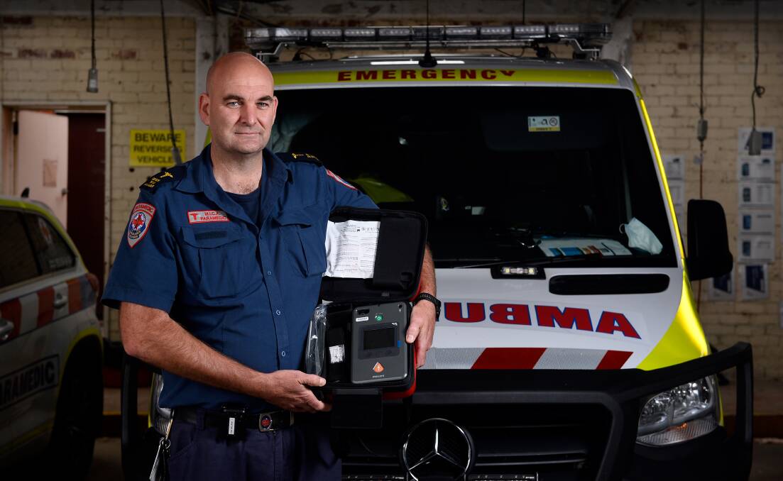 HEART STARTER: MICA paramedic Mark Brown with a defibrillator used to restart the heart in cases of cardiac arrest. There is a push to ensure all defibrillators are registered and available for use to save lives in the community. Picture: Adam Trafford
