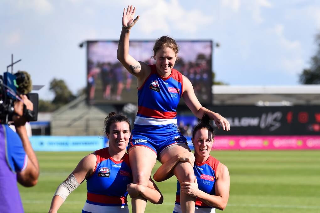 FINAL MOVE: Retiring Bulldog Ashleigh Guest is chaired off by Bonnie Toogood (left) and Brooke Lochland.