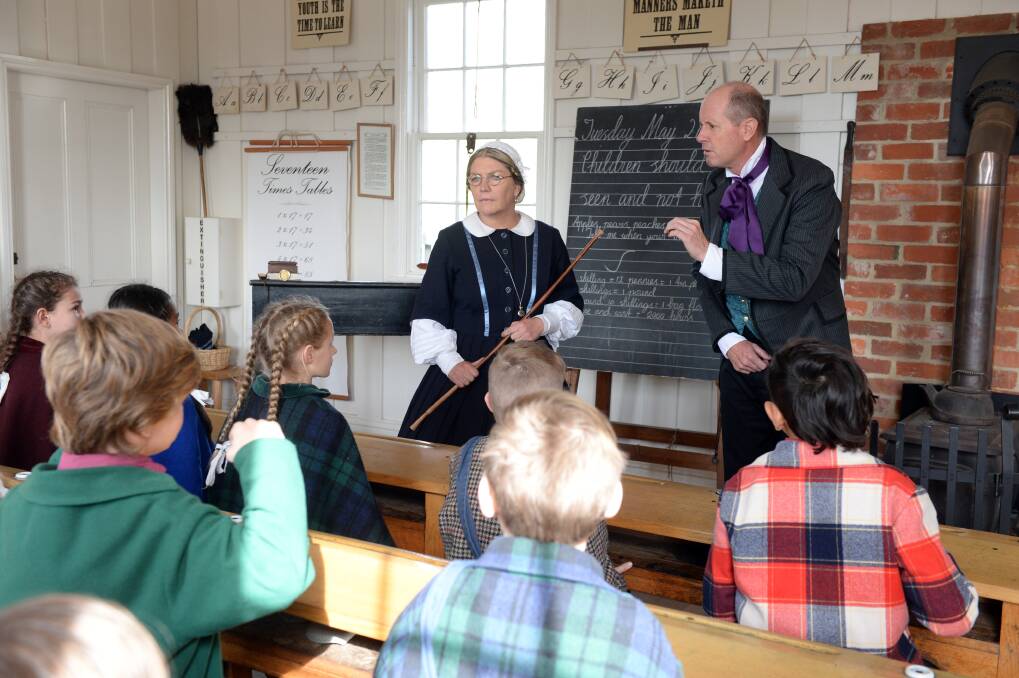 LESSONS: Sovereign Hill Schools principal Janine Baker and Ross Verinder take a lesson with visiting students in the costumed school. Picture: Kate Healy