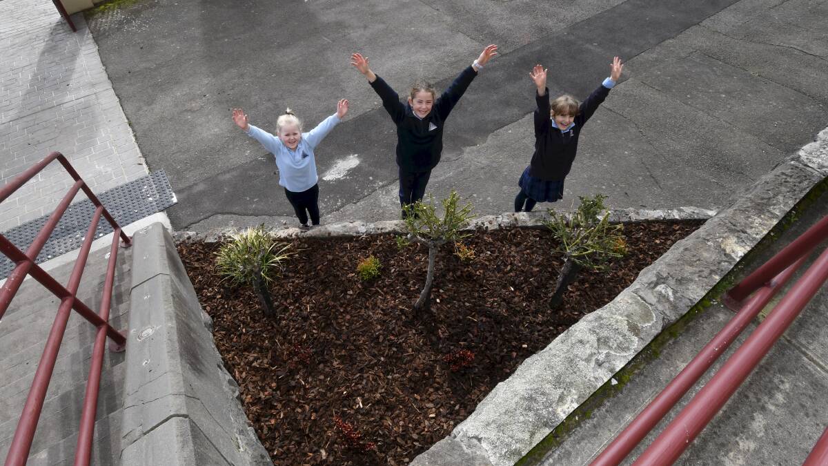 GREENERY: Macarthur Street Primary pupils Evora, Aleah and Abi with the new plants that will add colour to the front of the school. Picture: Lachlan Bence. 