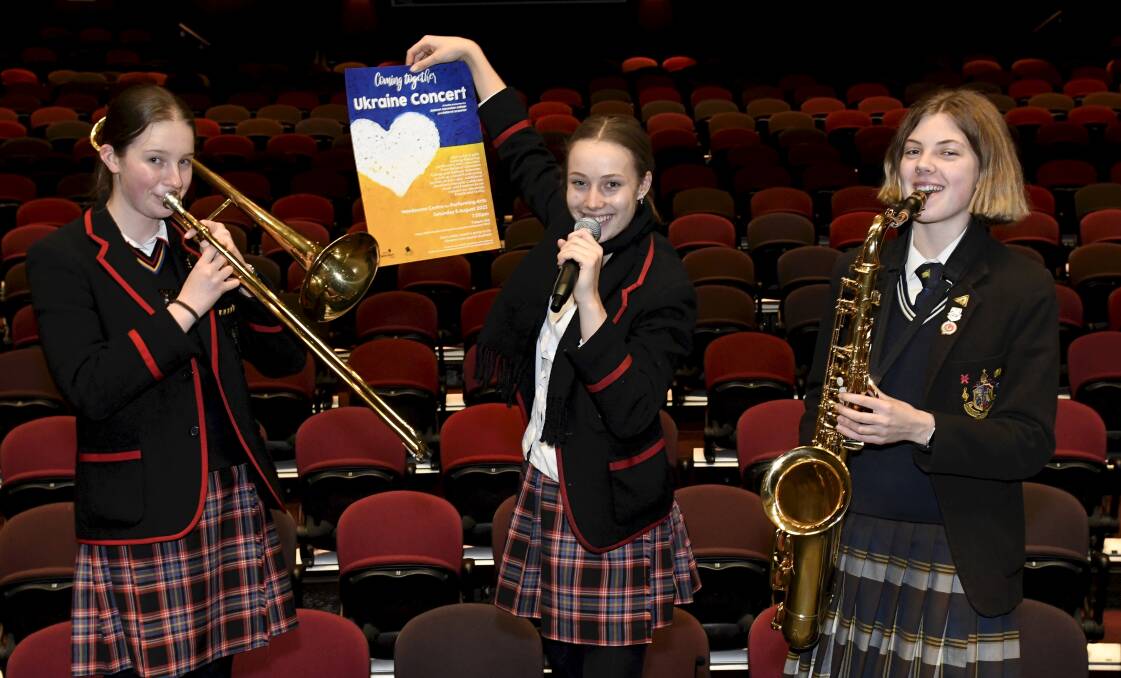 UNITED: Ballarat Clarendon College students Sophie Clarke and Georgina Kemp join Ballarat Grammar's Lola Speer ahead of a joint fundraising concert for the Ukraine. Picture: Lachan Bence