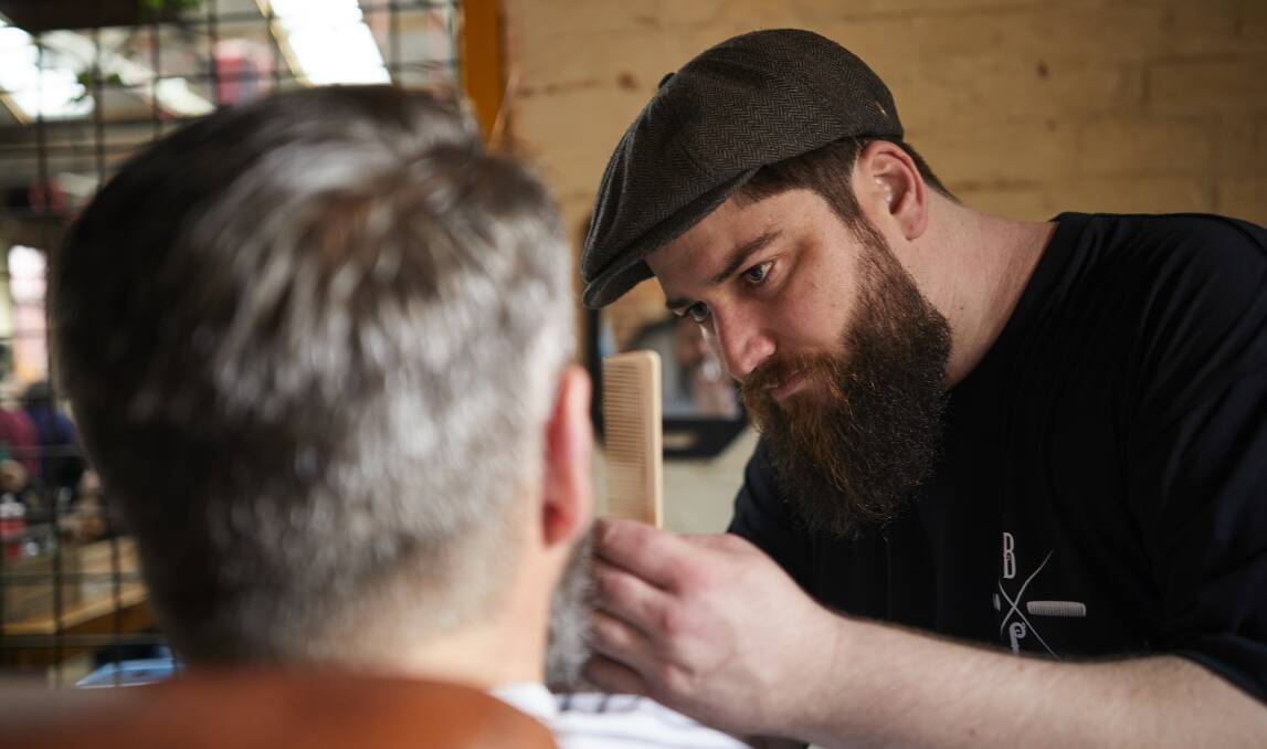 Ironbark Barbery barber Clayton Smith  preparing contestants for the beard competition as part of the 2017 Heritage Weekend. Picture: Luka Kauzlaric