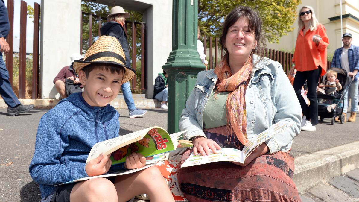 Baxter, 8, and Inca from Mt Helen enjoy the atmosphere of Clunes Booktown 2023. Picture by Kate Healy
