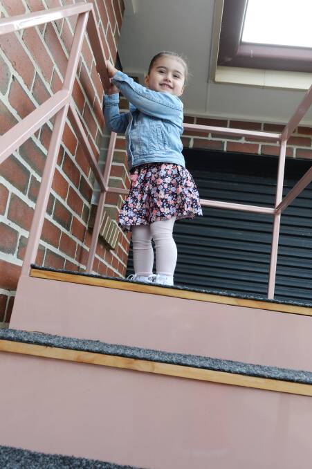 ON THE UP: Emma, 3, scales new heights walking up stairs built and donated to help her improve her mobility after suffering a stroke before she was born. Picture: Kate Healy