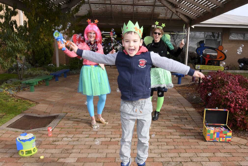 Alfredton Primary School grade one student Eli jumps for joy during a fun day with principal Laurel Donaldson and assistant principal Paula Sprague. Picture Lachlan Bence