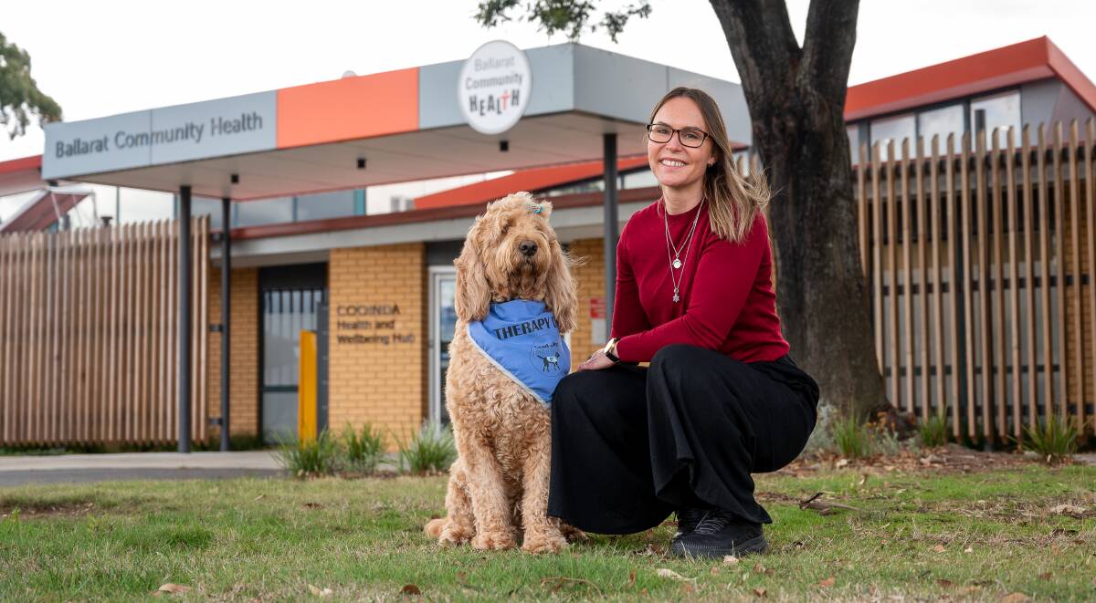HELPER: Therapy dog Ginny, a three-year-old Groodle, and her handler mental health worker Rachael outside Ballarat Community Health's Cooinda site. Picture: supplied