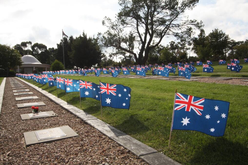 MARKED: Students from two Ballarat schools have helped cemetery staff place Australian flags on all World War I graves ahead of Anzac Day.