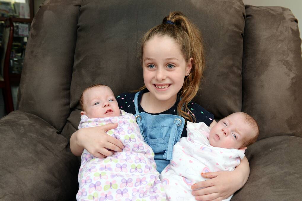 SISTERS: Big sister Trinity, 7, loves helping with her baby sisters Alexa and Emmie. Picture: Kate Healy