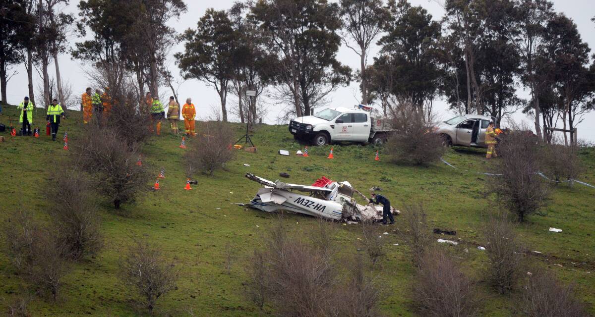 CRASH: Investigators and emergency service workers at the site of the Millbrook plane crash in September, 2015. Picture: Kate Healy