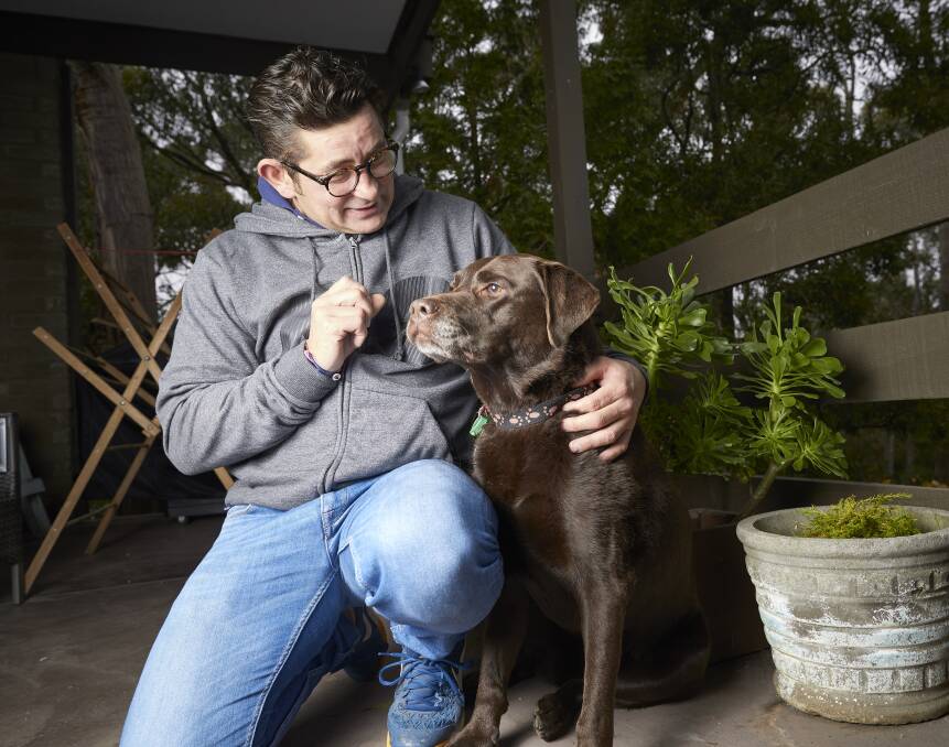 PUPPY LOVE: Andrew Giles and his rescue labrador Bessie will take part in the RSPCA Million Paws Walk at Victoria Park on Sunday. Picture: Luka Kauzlaric