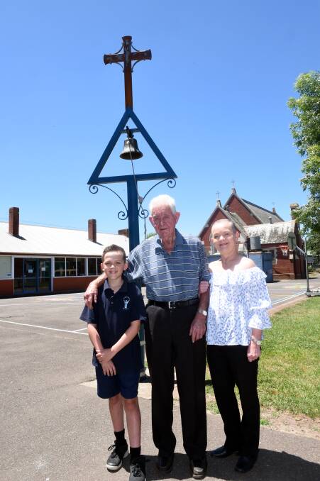 FAMILY TIES: Darcy Sellars, Leo Murphy and Cate Sellars with the bell tower that Mr Murphy built in the grounds of St Brendan's PS, Dunnstown. Picture: Jeremy Bannister