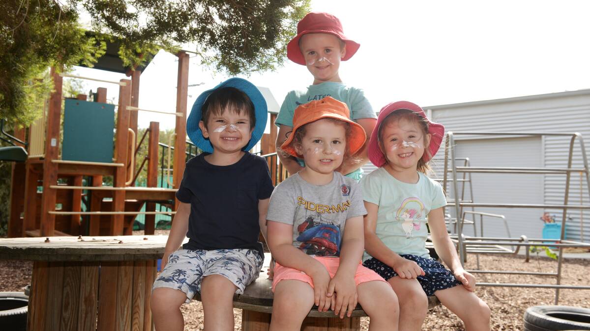 HATS ON: Iris Ramsay Kindergarten pupils Blake (back), Hudson, Thomas and Zahli show off their SunSmart skills in the playground of their Redan kinder. Picture: Kate Healy