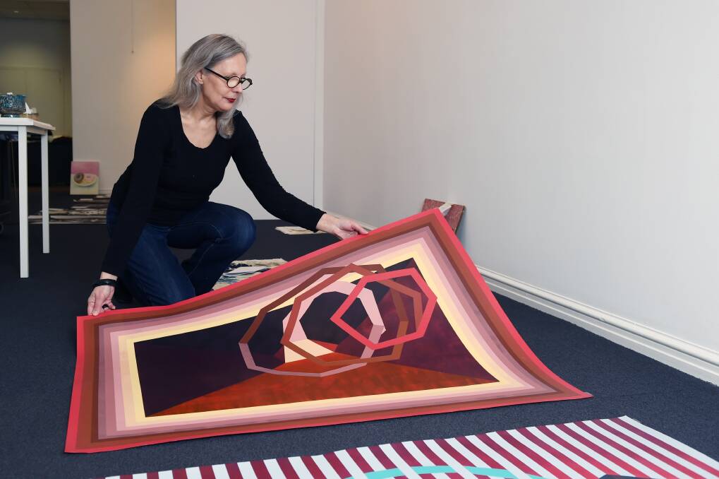 BENCHMARK: Post Office Gallery curator Shelley Hinton with Ebony Gulliver's work  Self Evident Map Painting 3, 2018.  Picture: Kate Healy