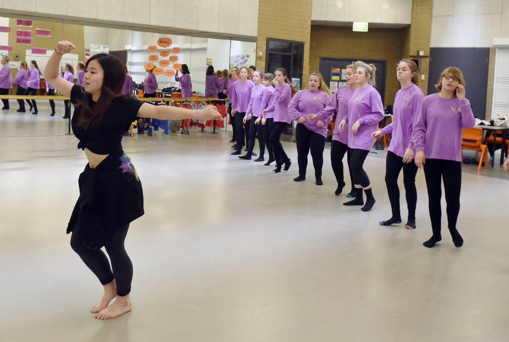 REHEARSALS: Ensemble dancer Sayaka Miyajima practices with members of the massed dance troupe from Mount Clear College as they prepare to join thousands of other students for the Victorian State Schools Spectacular show With The Beat. Picture: Kate Healy