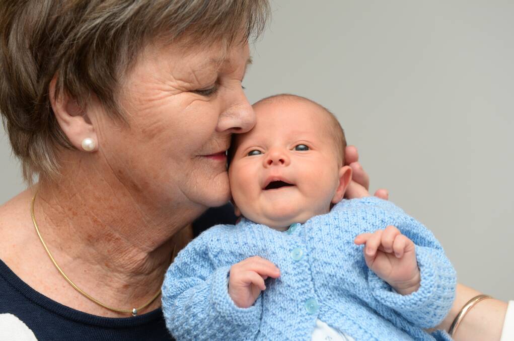 LOVE: Louis Clark, two weeks, gets a kiss from grandma Marie Clark. Picture: Kate Healy