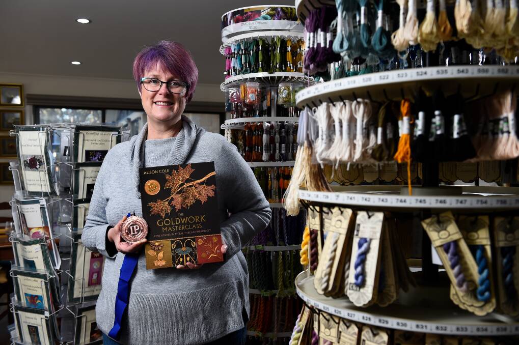 MEDAL: Alison Cole in her embroidery store with the bronze medal her book The Goldwork Masterclass won at the prestigious Independent Publishers Award. Picture: Adam Trafford