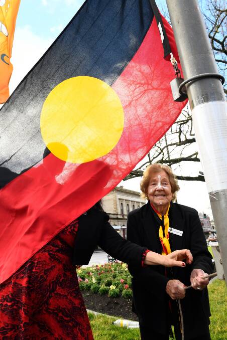 NAIDOC: Aunty Violet McPherson raises the flag during NAIDOC Week celebrations. (Picture by Adam Trafford/Ballarat Courier)
