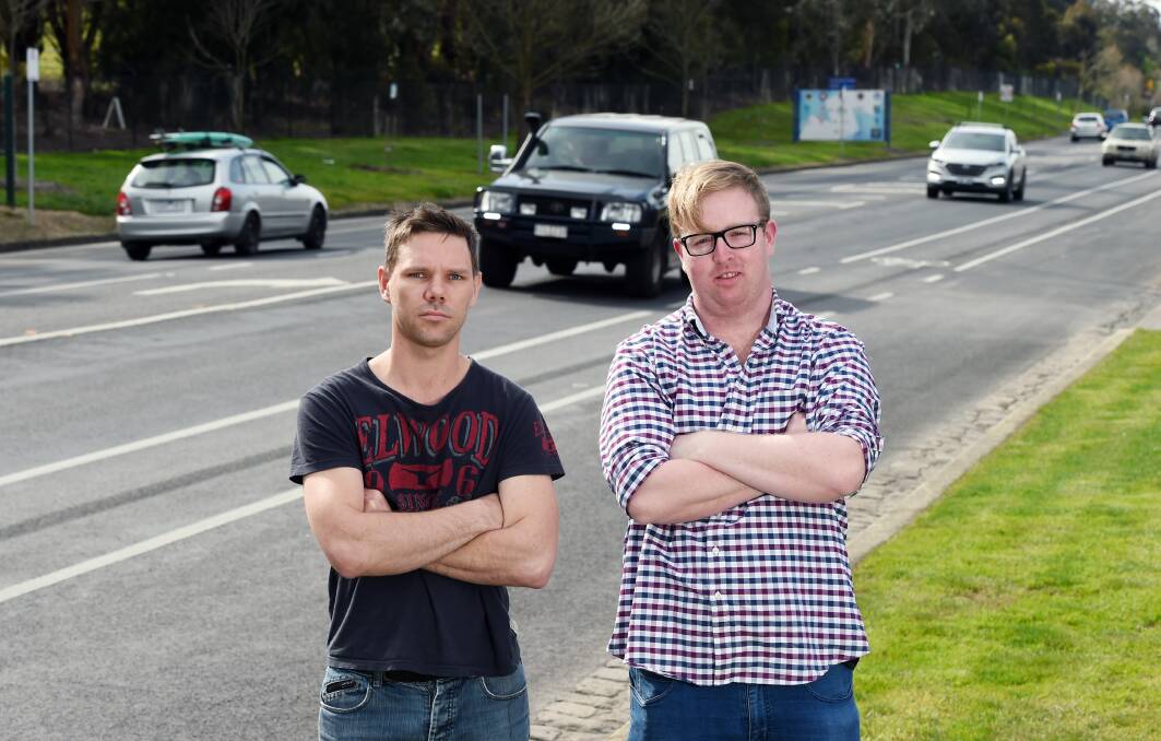 Concerned: Residents Shannon Graham and Charlie Dickson fear for the state of Ballarat's road network, with more heavy rainfall predicted this week. Picture: Kate Healy
