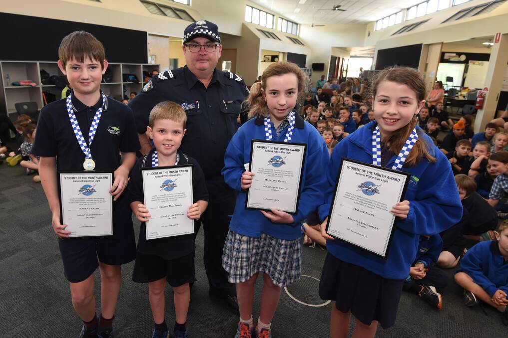 RESPECTFUL: Blue Light student of month award recipients, Mt Clear Primary School pupils Tarkyn, Frazer, Madeline and Haylee with Leading Senior Constable Des Hudson. Picture: Lachlan Bence.
