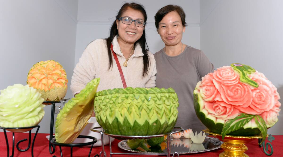 CULTURE DISPLAY: Linton's Khaekhai Stanfield and Portland's Kingjan Willis showcase the tradition Thai art of fruit carving. Picture: Kate Healy.
