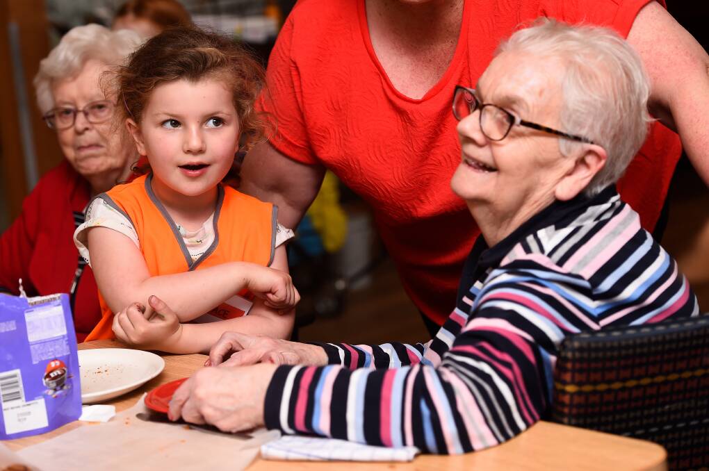 CONNECTION: Hailey House resident Sue helps Midlands Kindergarten child Grace bake biscuits on 'Circle Day'. Pictures: Adam Trafford 