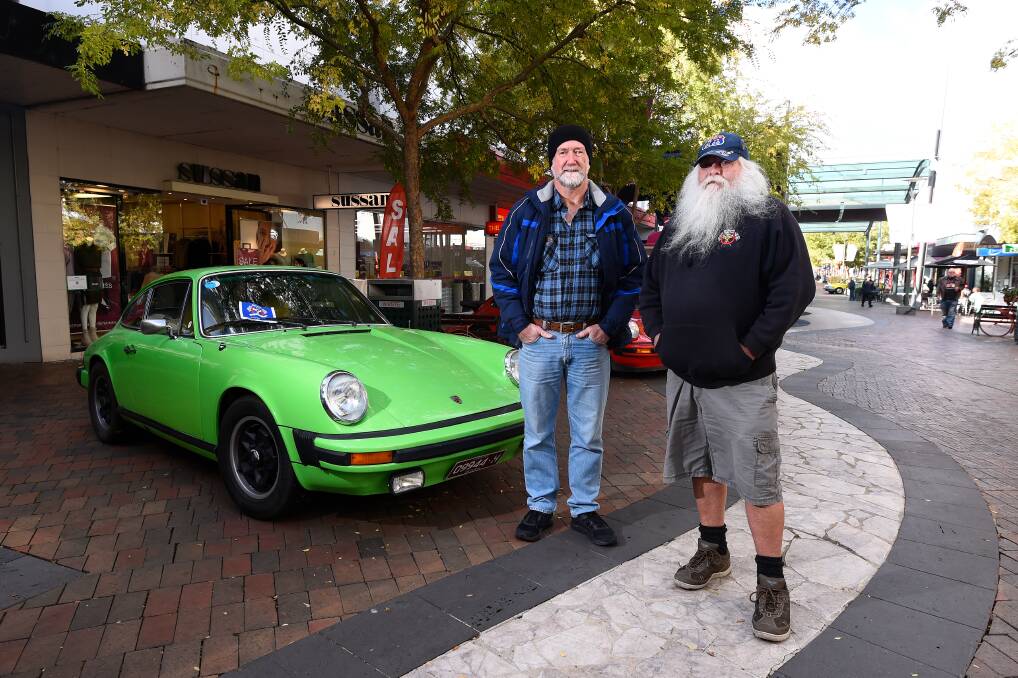VINTAGE: Chris Bourke and Ross Barnett with a 1974 Porsche 911S that was a favourite at the vintage car show at Bridge Mall on Saturday. Picture: Adam Trafford 