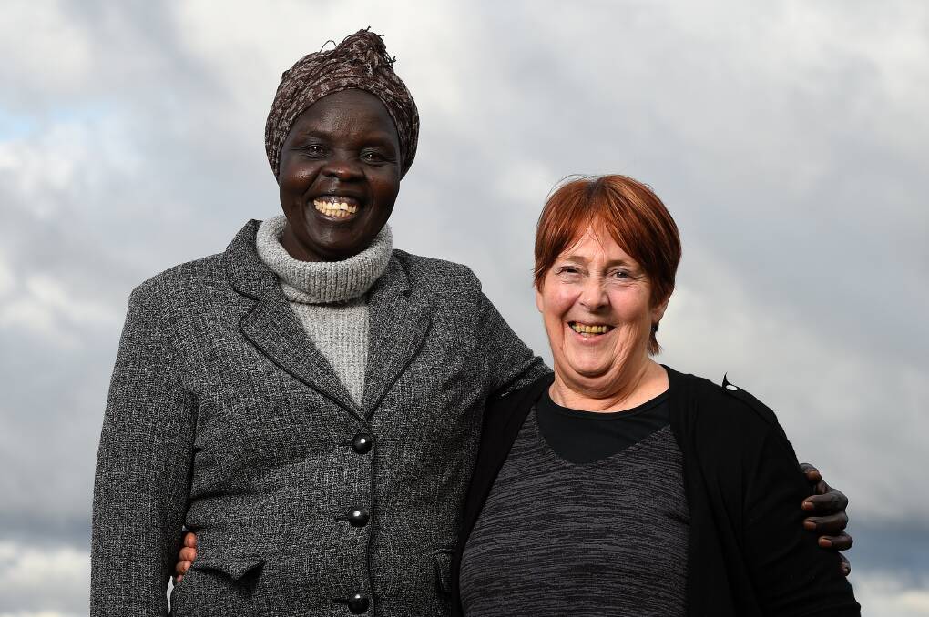 WORKING TOGETHER: Work and Learning Ballarat participant Mary Bukjiok reflects on her transition to work with centre team leader Jan Simmons. Picture: Adam Trafford 