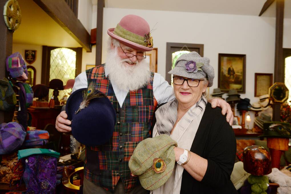 EXPERIENCE: Bob Petch tries on hats with regular customer Celia Beeton.