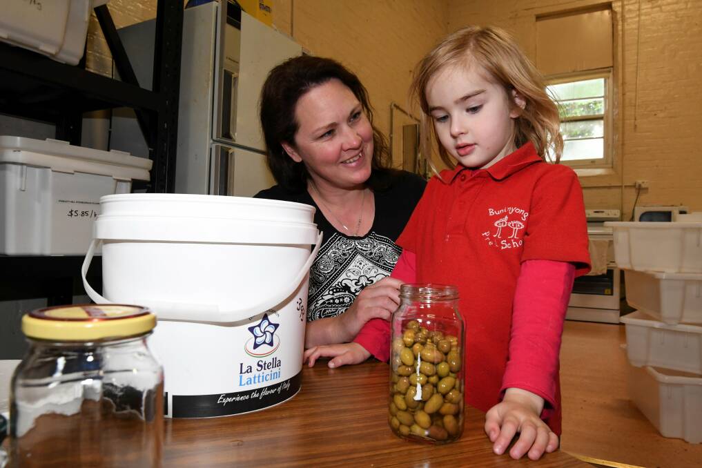 PRODUCE: Belinda Wardle and 4-year-old Maddison Wardle brought their jars to fill with local produce at the opening day of the Buninyong Community Collective in November. Picture: Lachlan Bence