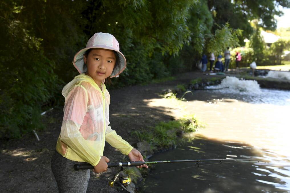 Seven-year-old Mia Bai fishing at Tuki Trout Farm. 