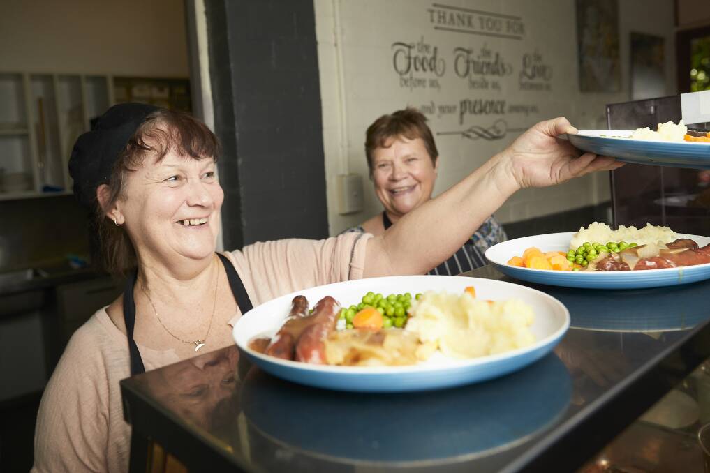 MEALS: Volunteers Marg Cornwell and Corrie Harbour serve up at the Breezeway Meals Program. It is one of 21 charities that would benefit from the creation of a food distribution centre in Ballarat. Picture: Luka Kauzlaric 