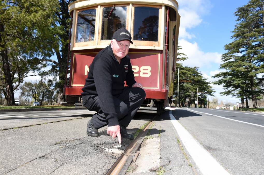 OLD TRACKS: Ballarat Tramway Museum operations manager Neville Britton points to a particularly rough section of the tram tracks. He's part of a funding push to replace the tracks. Picture: Kate Healy