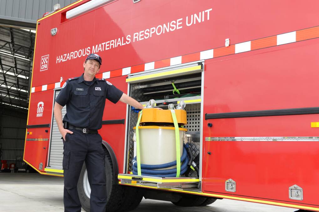 Leading firefighter Scott Burns with the Hazardous Materials Fire Truck from Lucas Fire Station in October. Picture: Kate Healy 