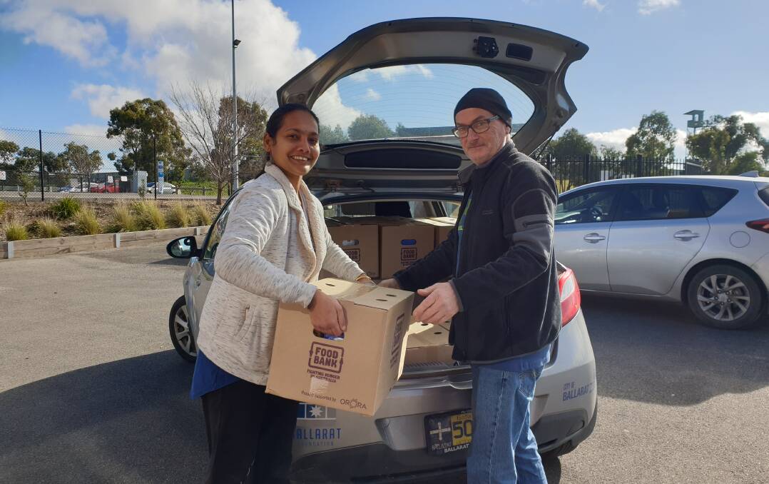 FOOD RELIEF: Padma Giri and Phil Waters prepare to deliver food relief packages to schools and universities as part of the Ballarat Foundation's new program. Picture: Ballarat Foundation
