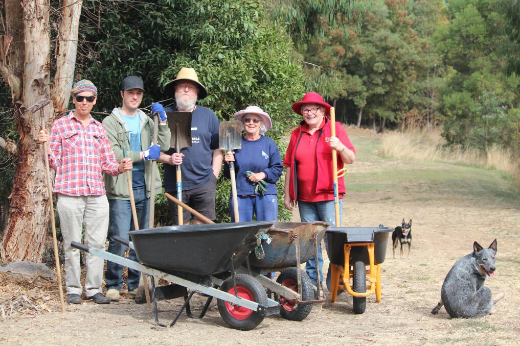 EMPTY WHEELBARROWS: Black Hill residents Michael Westlake, Julian Potter, Neil Huybregts, Cheryl Sawall, Jeni Eastwood and dogs Hamish and Matilda were left without mulch during their working bee on Sunday. Picture: Rochelle Kirkham