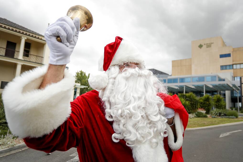 HO, HO, HO: Ray Trounson, on Sunday known as Santa, brings smiles to the faces of children at St John of God Hospital during their Christmas celebrations. Picture: Dylan Burns 