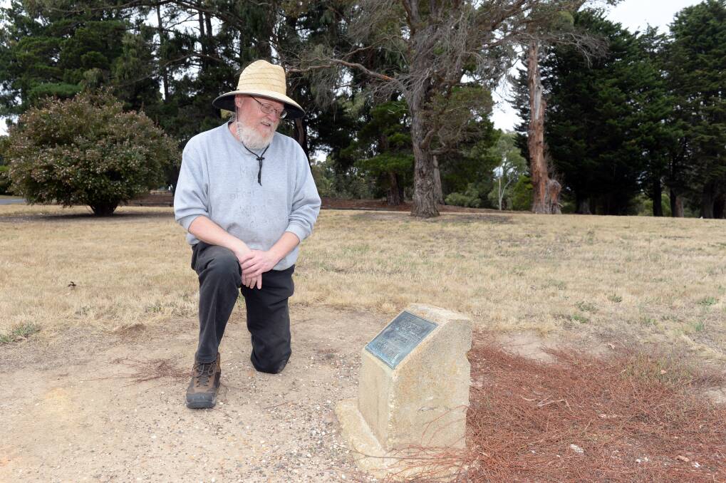 RE-PLANTING: Friends of Black Hill president Neil Huybregts reads a plaque that signifies the planting of the 'Tree For Life', but the tree not longer exists. Pictures: Kate Healy 