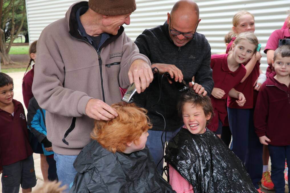 Cameron and Gus' fathers shave their heads to raise funds for melanoma research. 