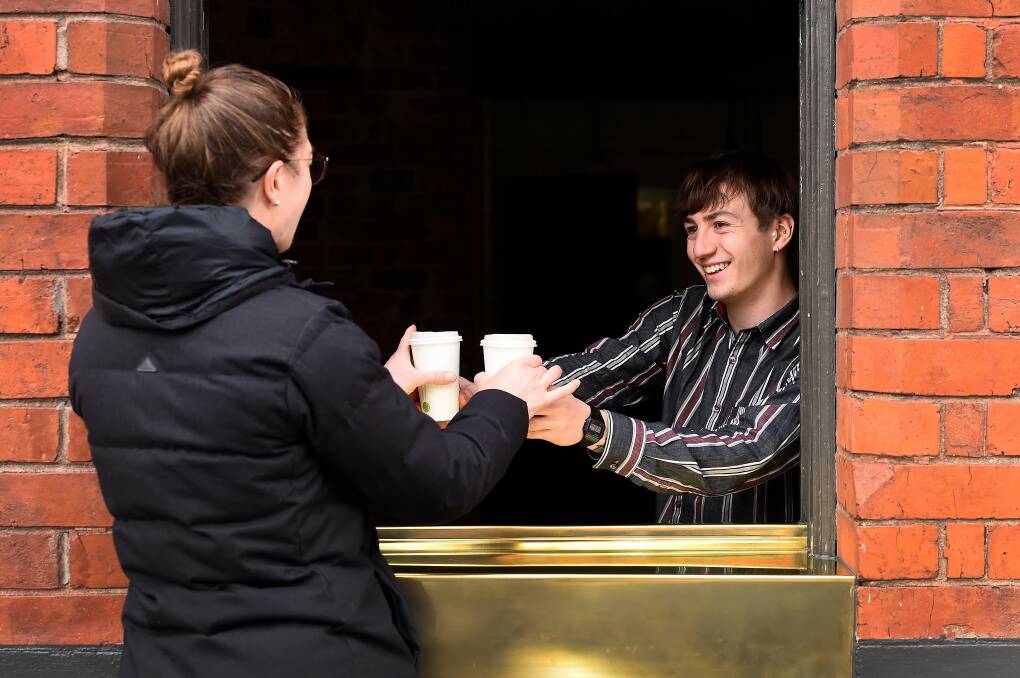 SOCIAL DISTANCING: A cafe in Ballarat delivering coffee through their pick up window. Picture: Adam Trafford 