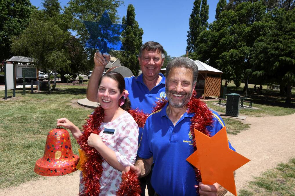 CHRISTMAS SPIRIT: Peita McNaught, Ian Voigt and David Page prepare for the Buninyong Carols by Candlelight. Picture: Lachlan Bence 