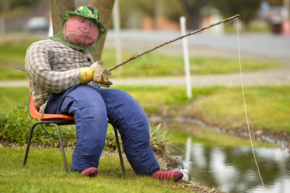 FUNNY FISHERMAN: A dummy fishing in a flooded drain on Talbot Road, Clunes, has gained community attention and laughter. Picture: Dylan Burns. 