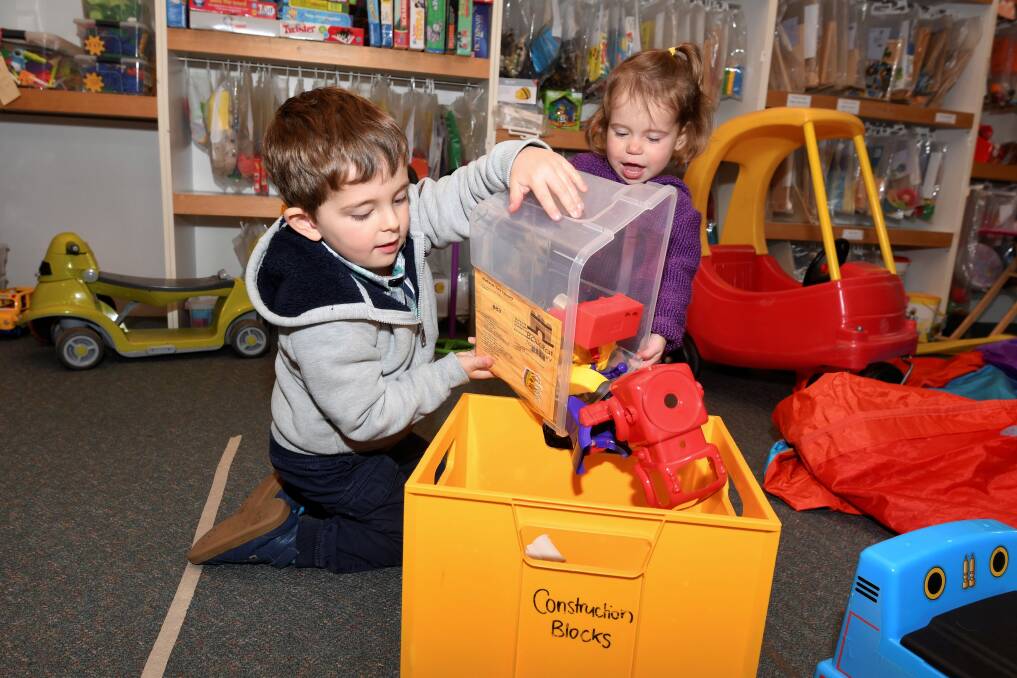PLAY TIME: 3-year old William Smith and 21-month old Sophie Smith pack up toys at the Ballarat Toy Library. Picture: Lachlan Bence 