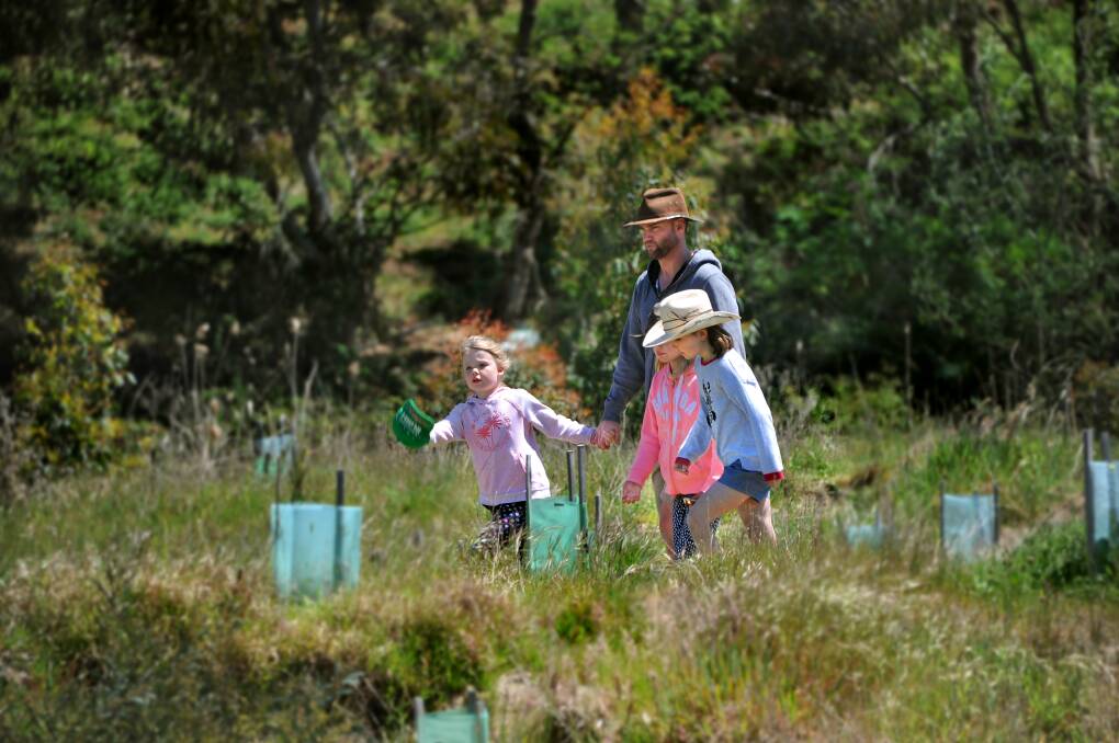 COMMUNITY: A family see the work of the Napoleons/ Enfield Landcare Group on the Open Day in October. Picture: David Fletcher