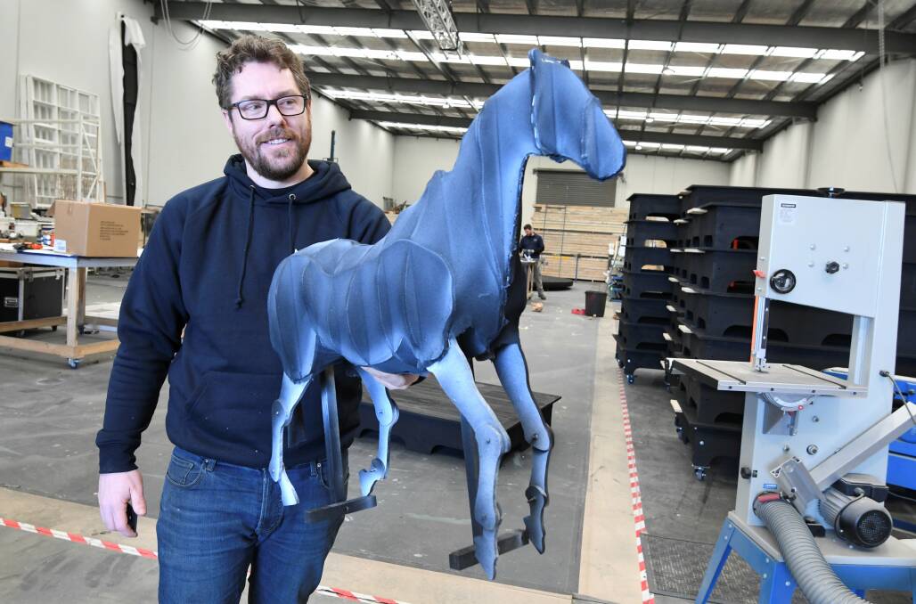 CREATIVE: NJW Designs owner Nathan Weyers holds a model that was used to make automated horses for a production of Cinderella. Pictures: Lachlan Bence 