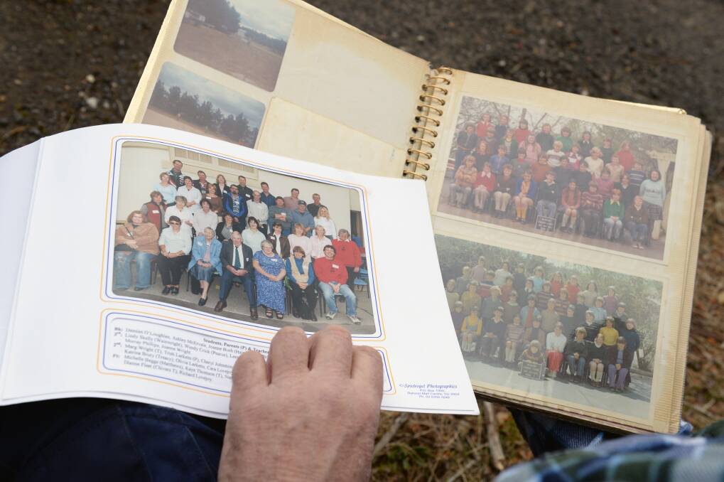 CONNECTION: Damian O'Loughlan shows old class photos from the Beaufort Primary School. Picture: Kate Healy 