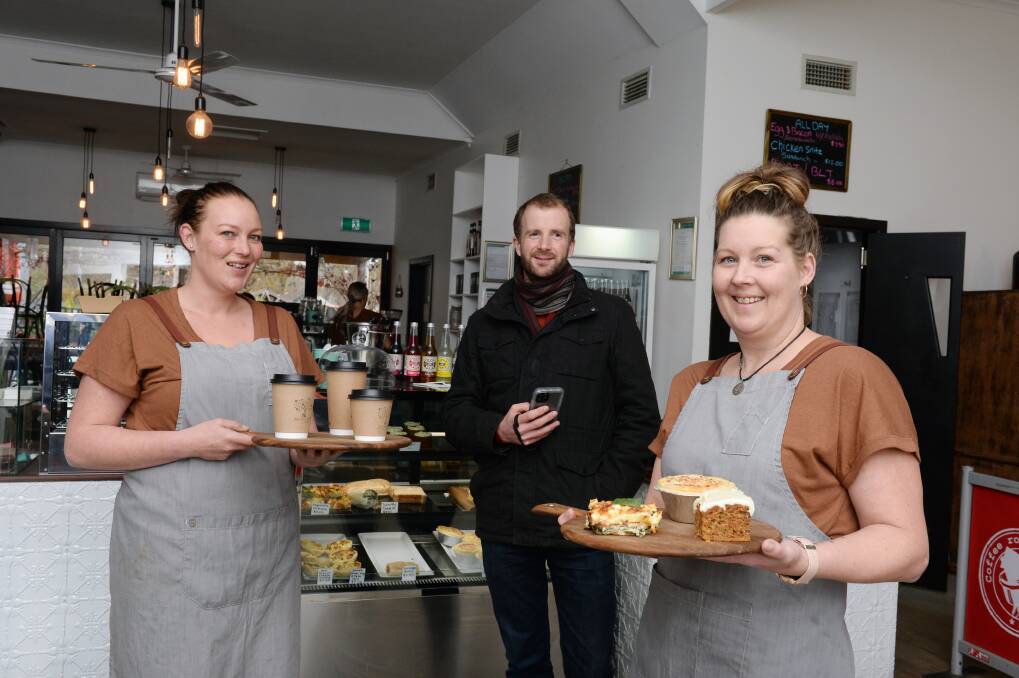 PUSHING ON: Rose and Oak Cafe staff member Beth Campbell, Clunes Tourism and Development Association treasurer Jason Judd and Rose and Oak cafe staff member Cassandra Curr. 