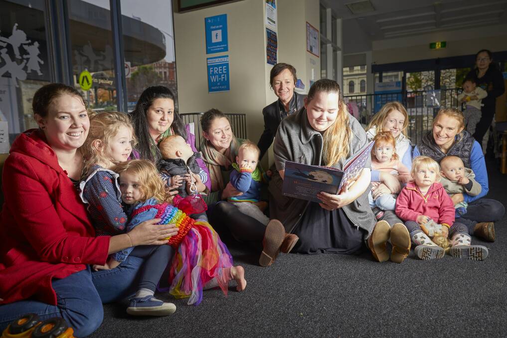 READ: Parent place volunteer Jane Sullivan, Cr Belinda Coates and Parent Place visitors read Hickory Dickory Dash for National Simultaneous Storytime. Picture: Luka Kauzlaric